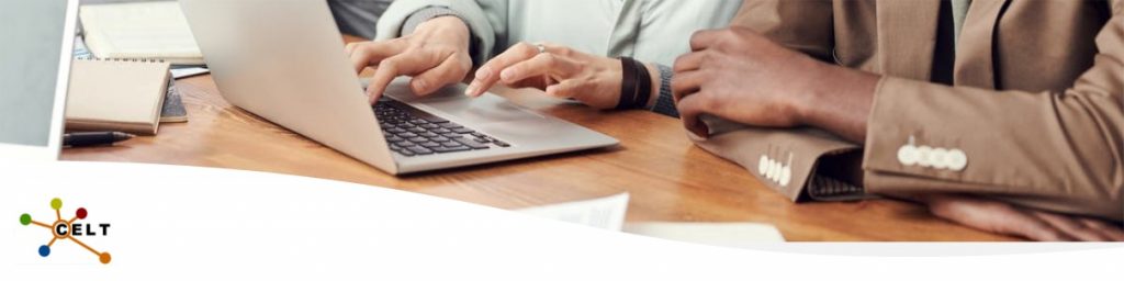 Close up photo of people using a laptop